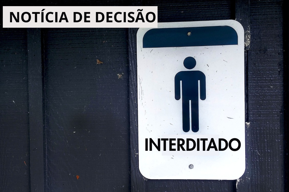 Banner com fundo preto, à direita uma placa de interditado.