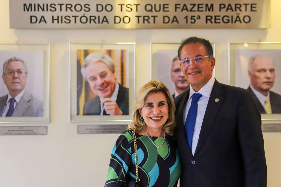 Dra. Ana Paula e ministro Campbell posa para foto em frente a galeria de ministros oriundos do TRT-15