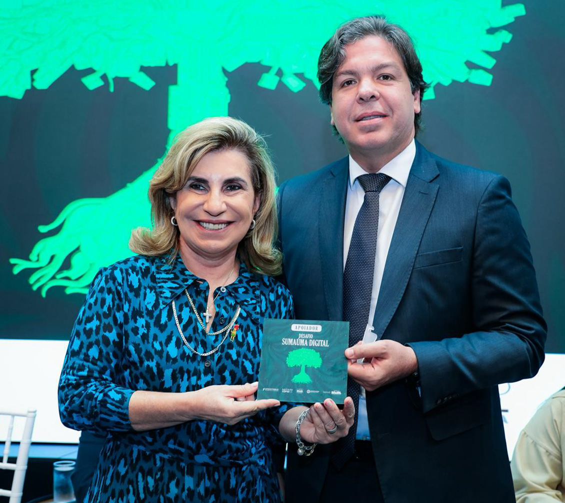 "Uma mulher e um homem posam para a foto segurando um selo"