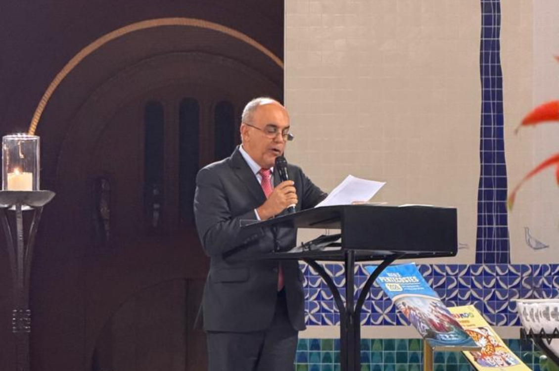 "Ministro Cláudio Brandão está no altar central da Basílica com o microfone na mão, fazendo a leitura da Carta de Aparecida"