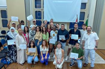 imagem de um grupo de pessoas posando para foto com certificados nas mãos